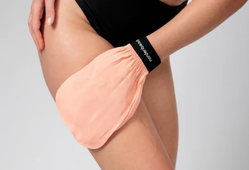 model holding 100% turkish silk exfoliating glove